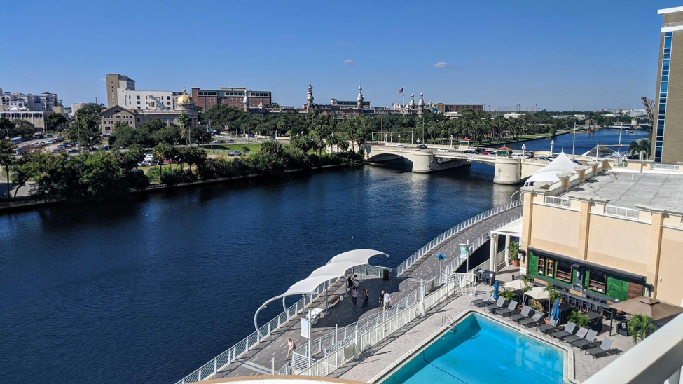 Hotel balcony that overlooks a river and the city.