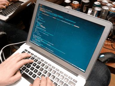 Someone writing code on a laptop.